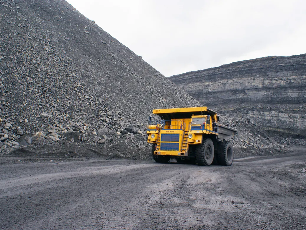 Mining haul truck on a gravel road between stockpiles